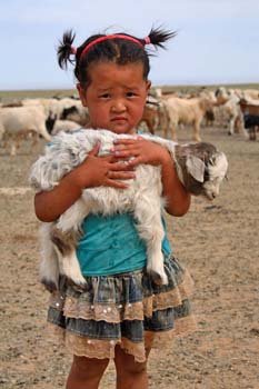 <b>Mongolia, Gobi Desert</b>, Young girl with a lamb