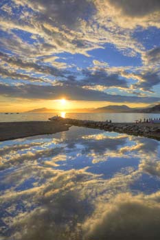 <b>Italy, Sestri Levante</b>, Vibrant sunset reflected in the sea